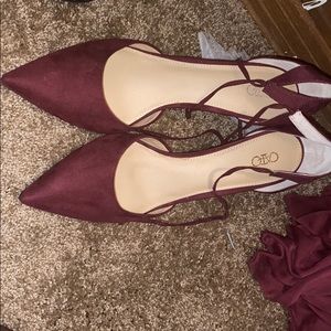 Short heeled, wine color shoes.